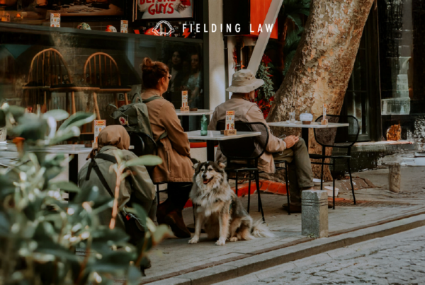 People sitting at a cafe with a dog