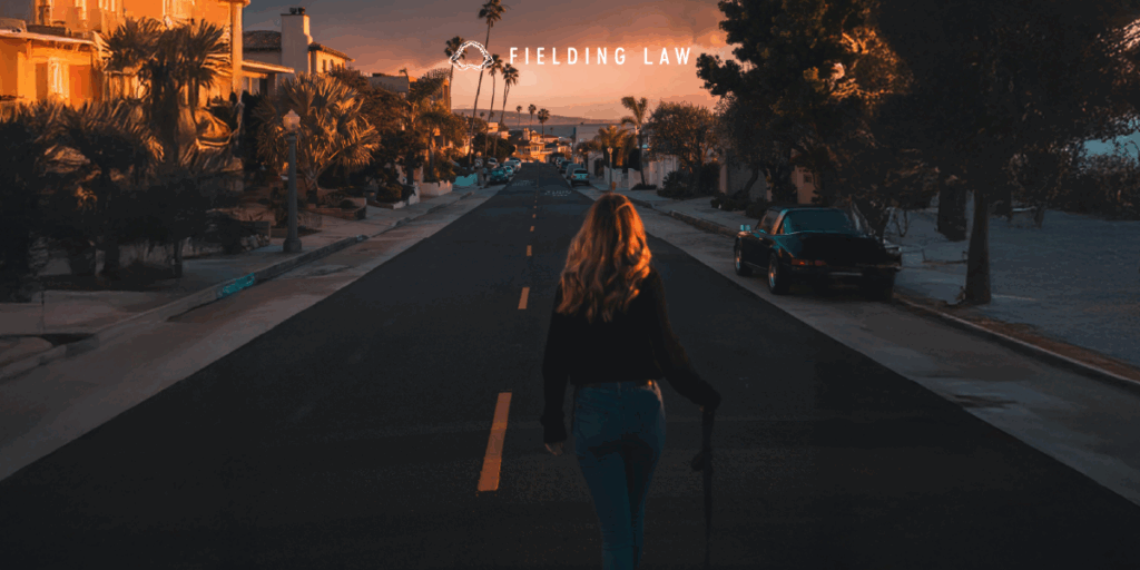 social media influencer standing in the middle of a street with a sunset in the background