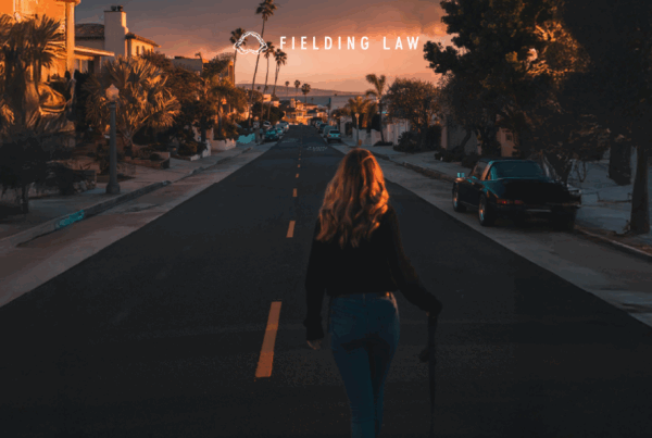 social media influencer standing in the middle of a street with a sunset in the background
