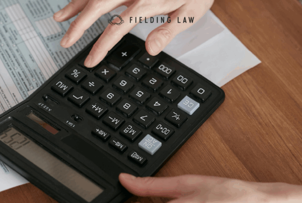 Person with a medical bill and calculator