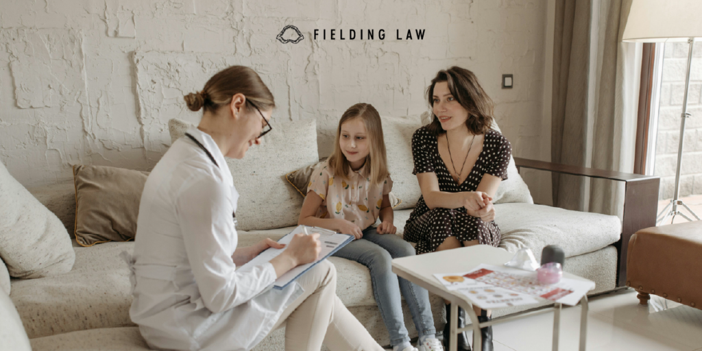 Brain doctor speaking with a child and parent