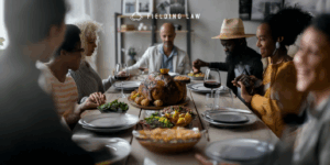 People sitting at a table for thanksgiving food