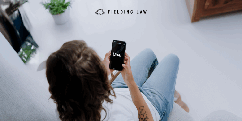 person looking at Uber app in phone