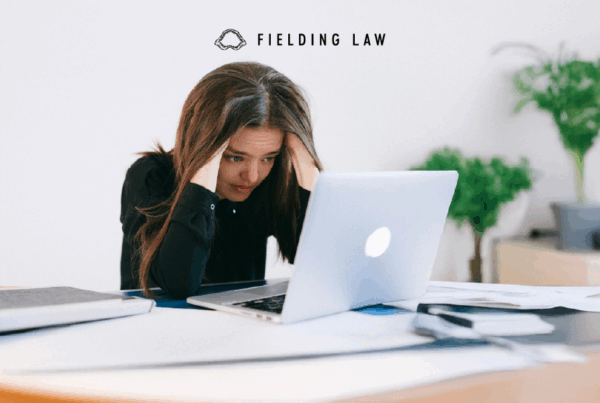 A person looking at a computer screen stressed out