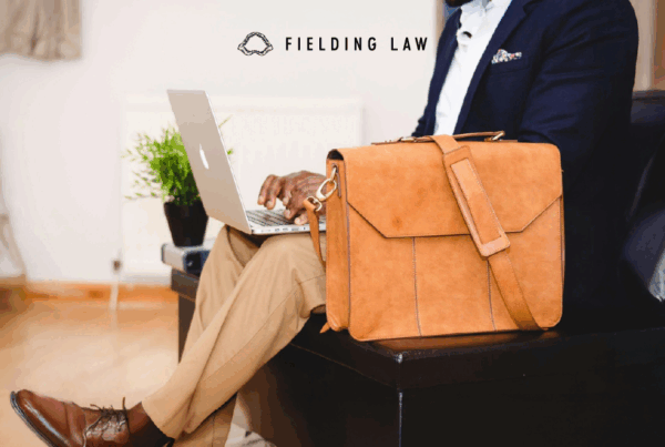 Businessman sitting in a chair with a laptop and a briefcase
