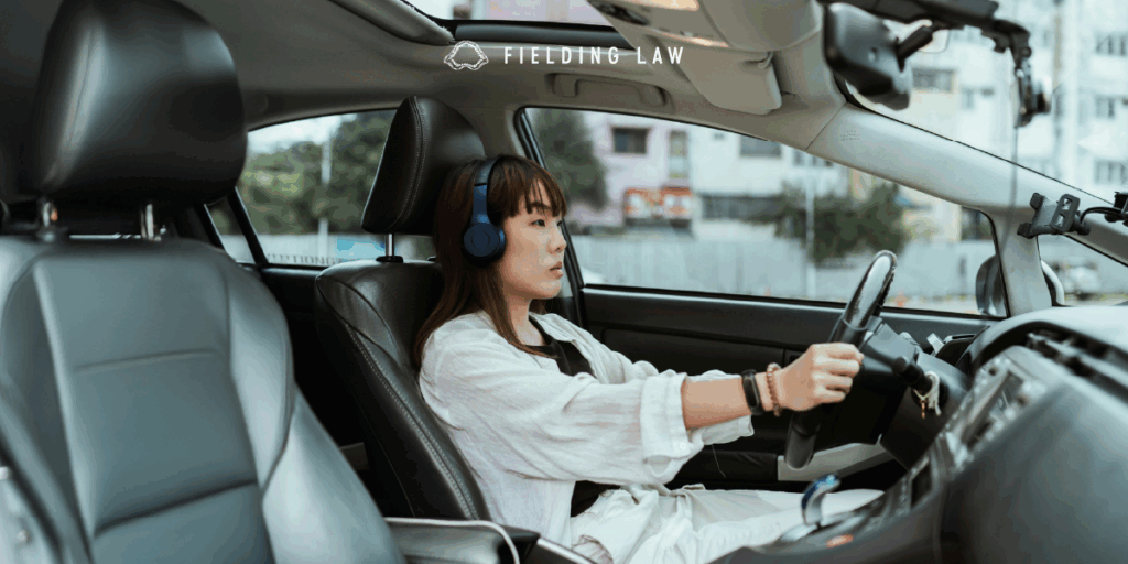 Woman driving wearing headphones