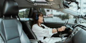 Woman driving wearing headphones
