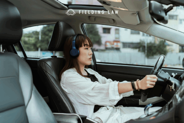 Woman driving wearing headphones