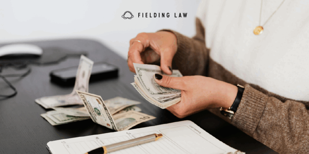 Person counting money from health insurance benefits