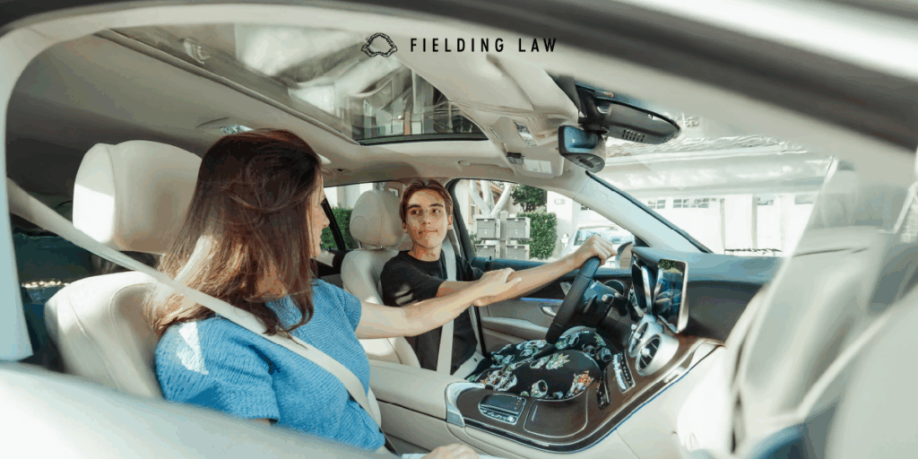 student driver in a car with parent