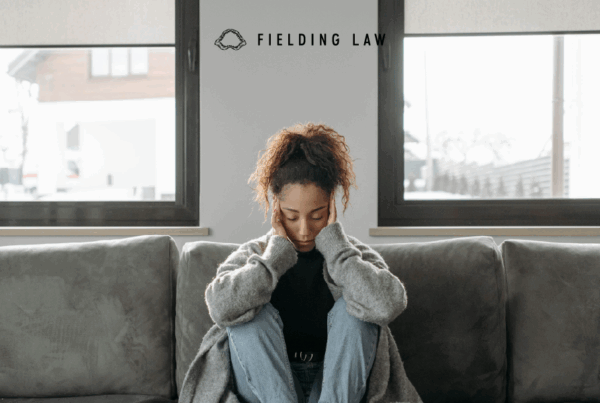 person with a brain injury holding their head