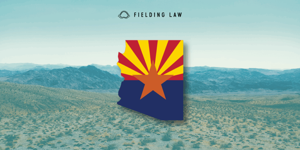Arizona state flag in the shape of arizona on an Arizona desert landscape