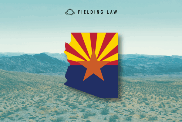 Arizona state flag in the shape of arizona on an Arizona desert landscape