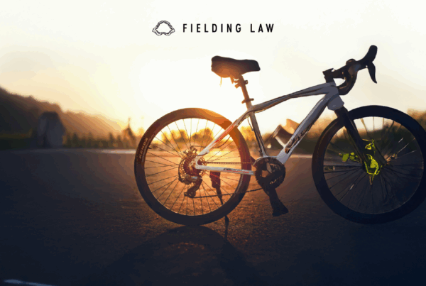 bicycle in a parking lot with the sun shining through the rear wheel