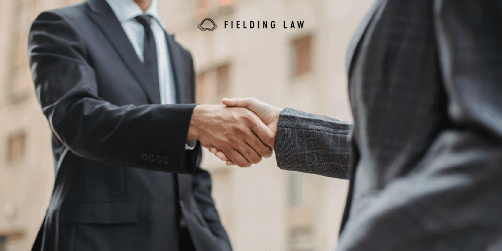 injury attorney shaking hands with a client