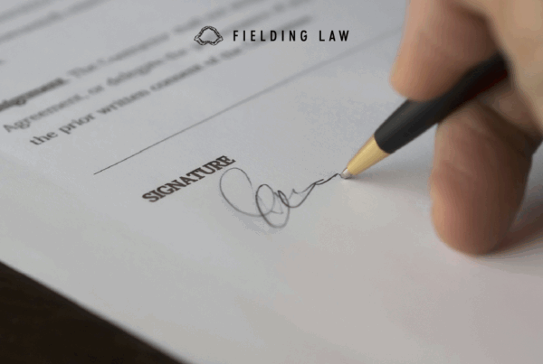 person signing a release agreement form
