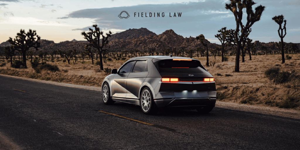 Car driving on an Arizona desert road at dusk