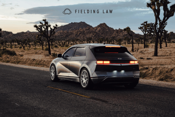 Car driving on an Arizona desert road at dusk