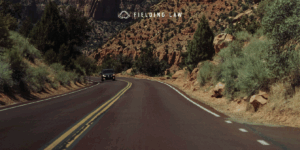 car on an arizona highway with a mountain in the background