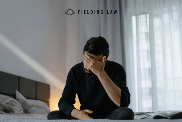 a person with their head in their hand upset over a loss