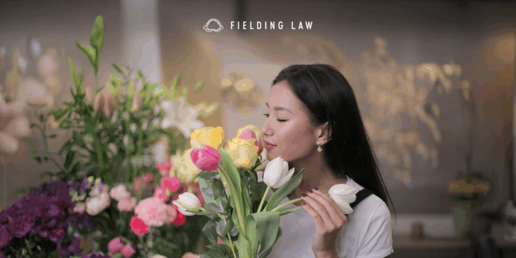 woman smelling a bunch of flowers