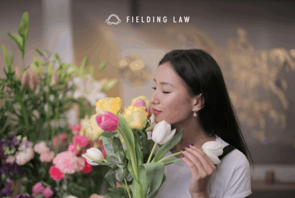 woman smelling a bunch of flowers
