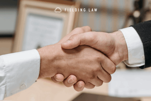two people shaking hands at an attorney office