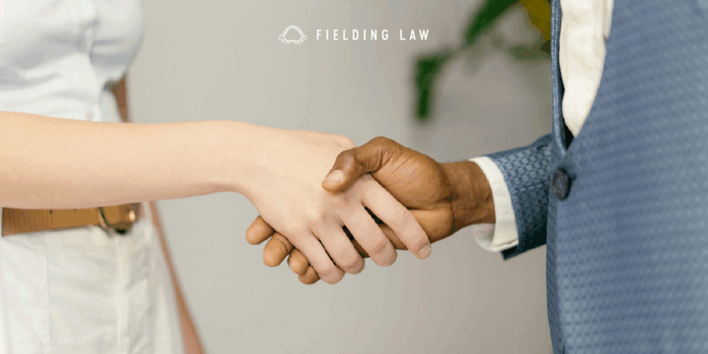 Two people shaking hands in a professional setting