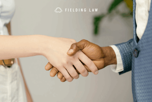 Two people shaking hands in a professional setting