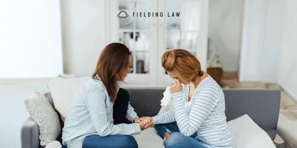 Two people. One is going through a crisis the other is consoling her