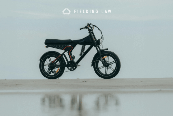 E-Bike standing upright on pavement with a blue sky behind it
