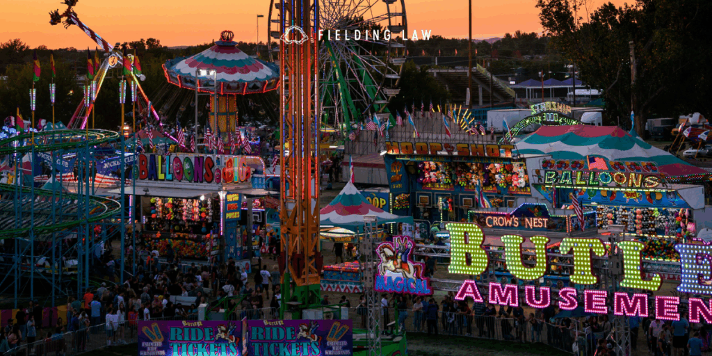 Midway of a fair with all the rides lit up at dusk