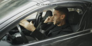 A man in the car with an angry face using aggressive gestures