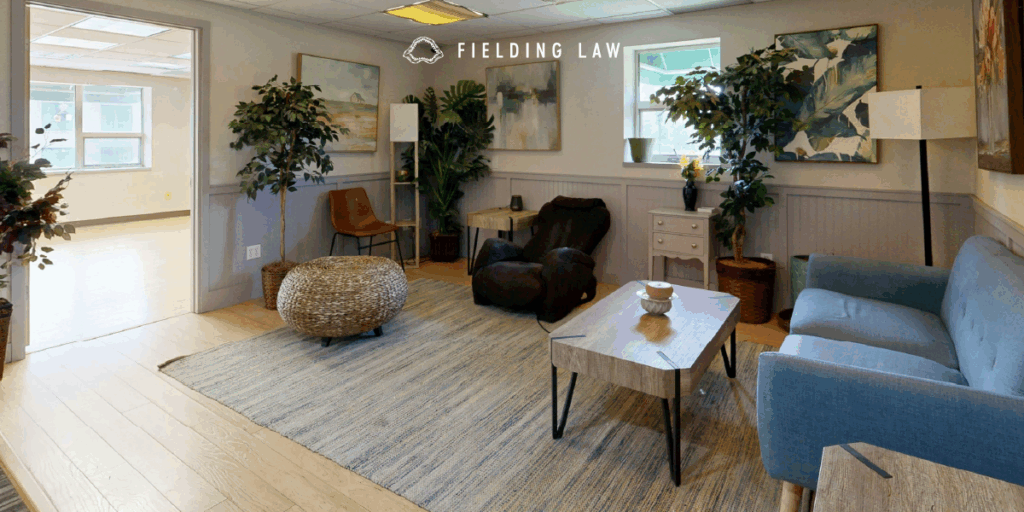 inside a sober home. Chairs, a rug, coffee table and a sofa